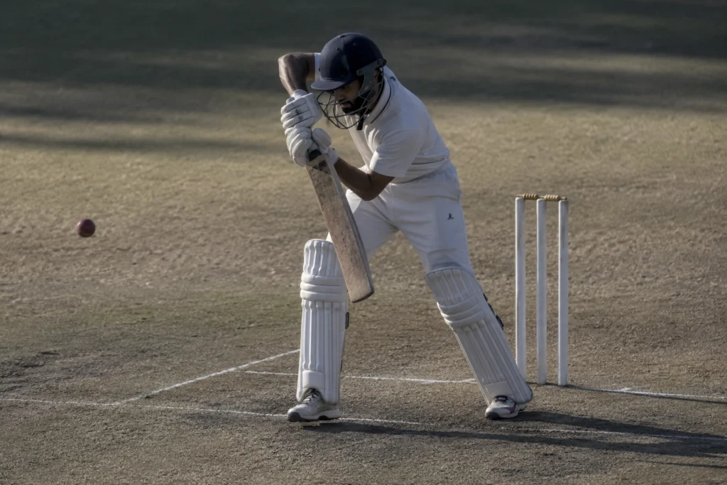 A cricket batsman in a defensive stance, illustrating patience and endurance over a long innings