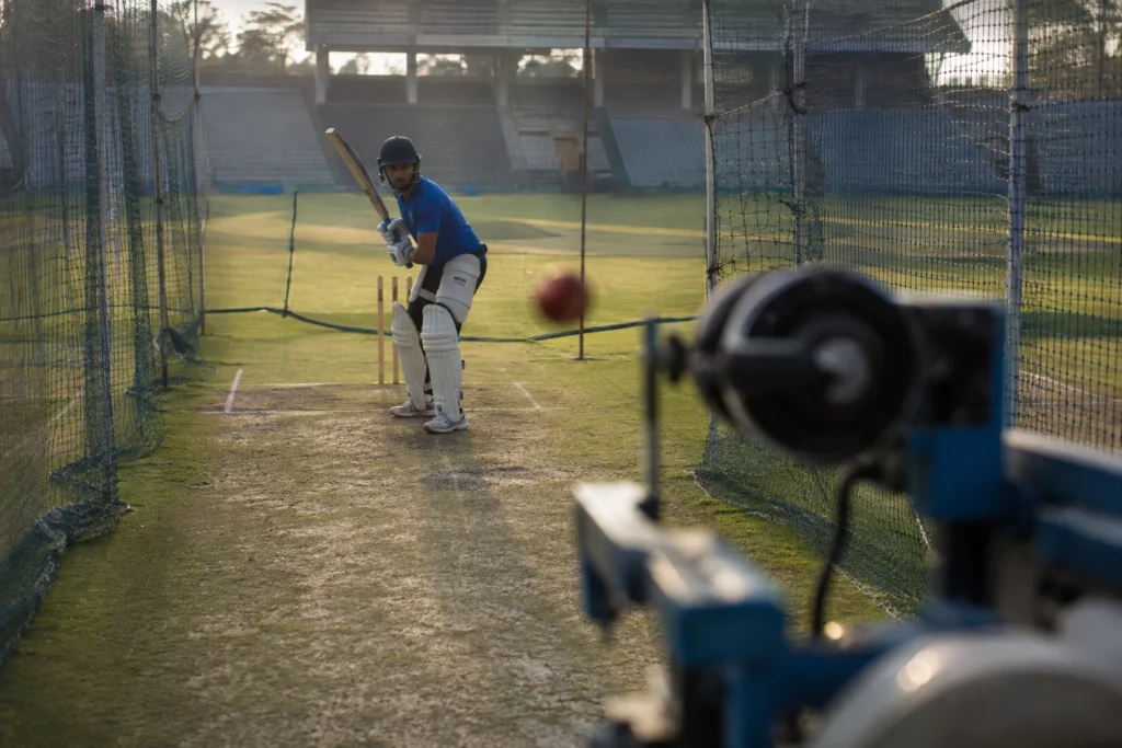 A cricketer training against a bowling machine at high speed, representing repetition-built skill